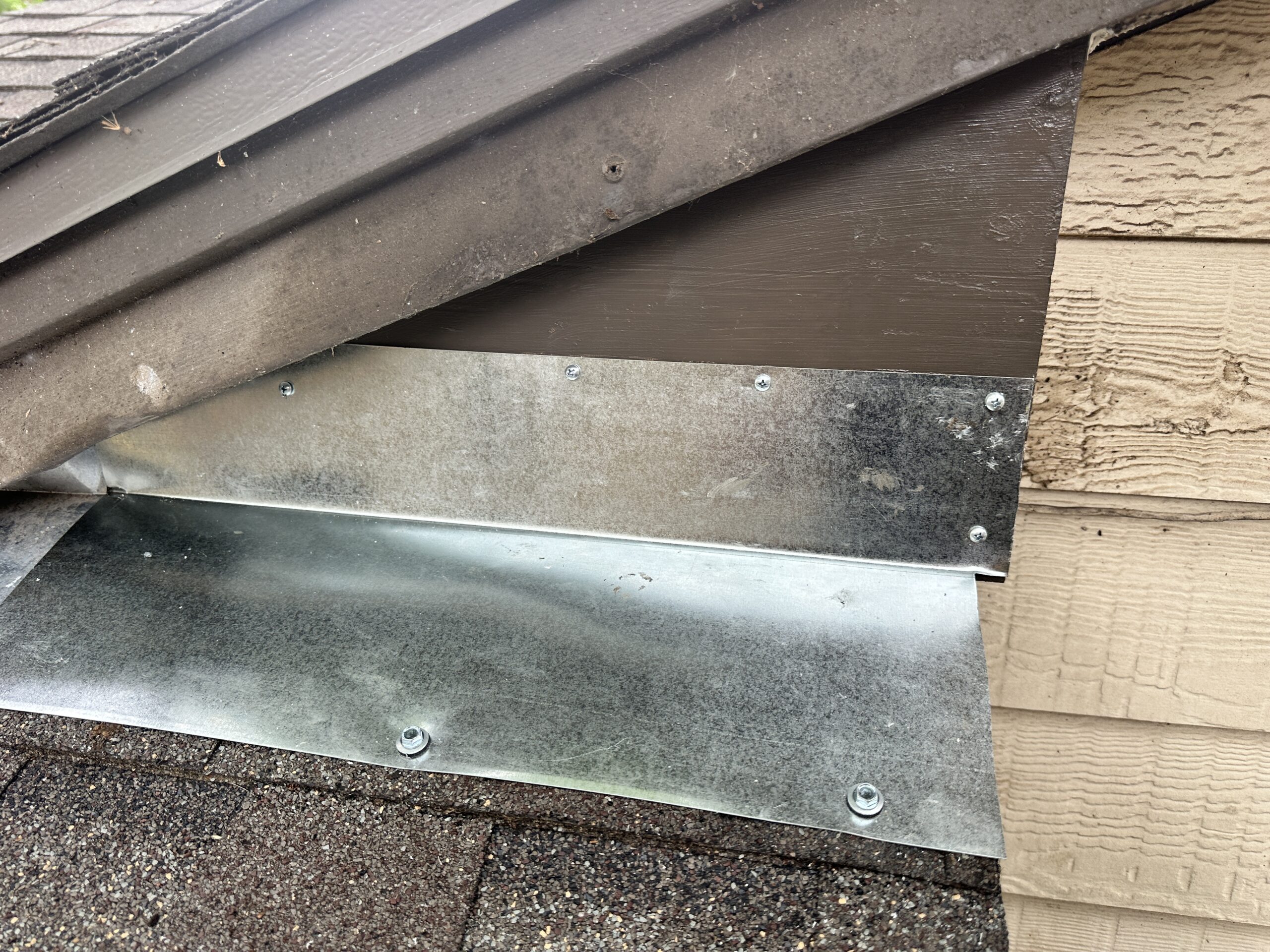 Completed wood rot repair with new metal flashing installed on roof fascia