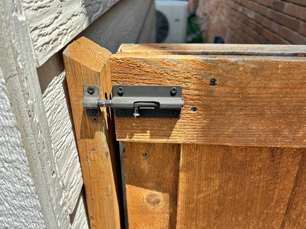 Wooden gate re-hung with a new latch in a Dallas side yard