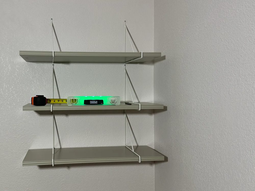 Three wall shelves installed level on a bedroom wall in Dallas