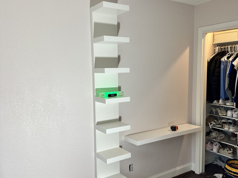 Tall white wall shelf unit and floating desk installed in a girls' bedroom in Lakewood, Dallas