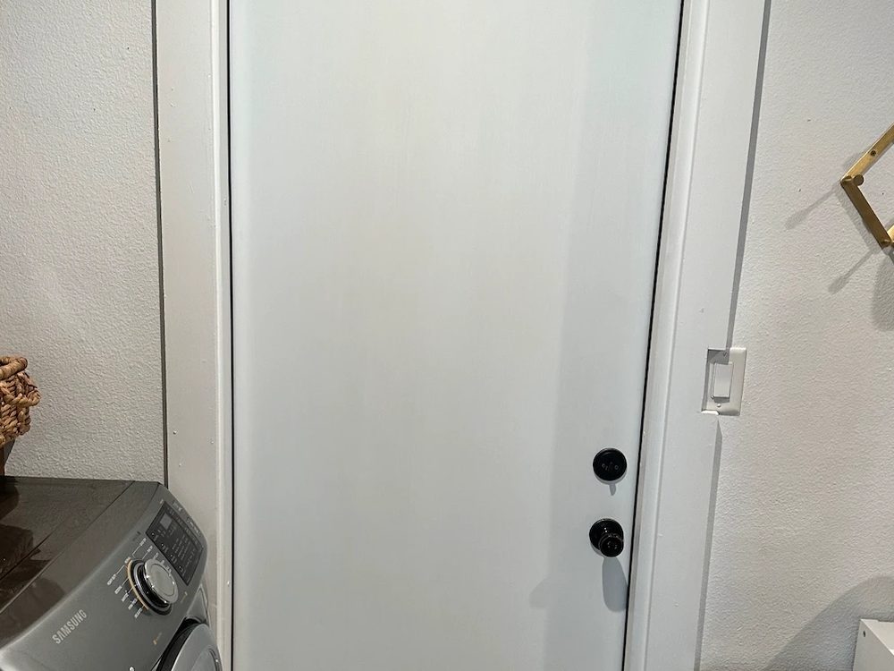 New exterior door with weatherstripping and threshold installed in a Midway Hollow home in Dallas