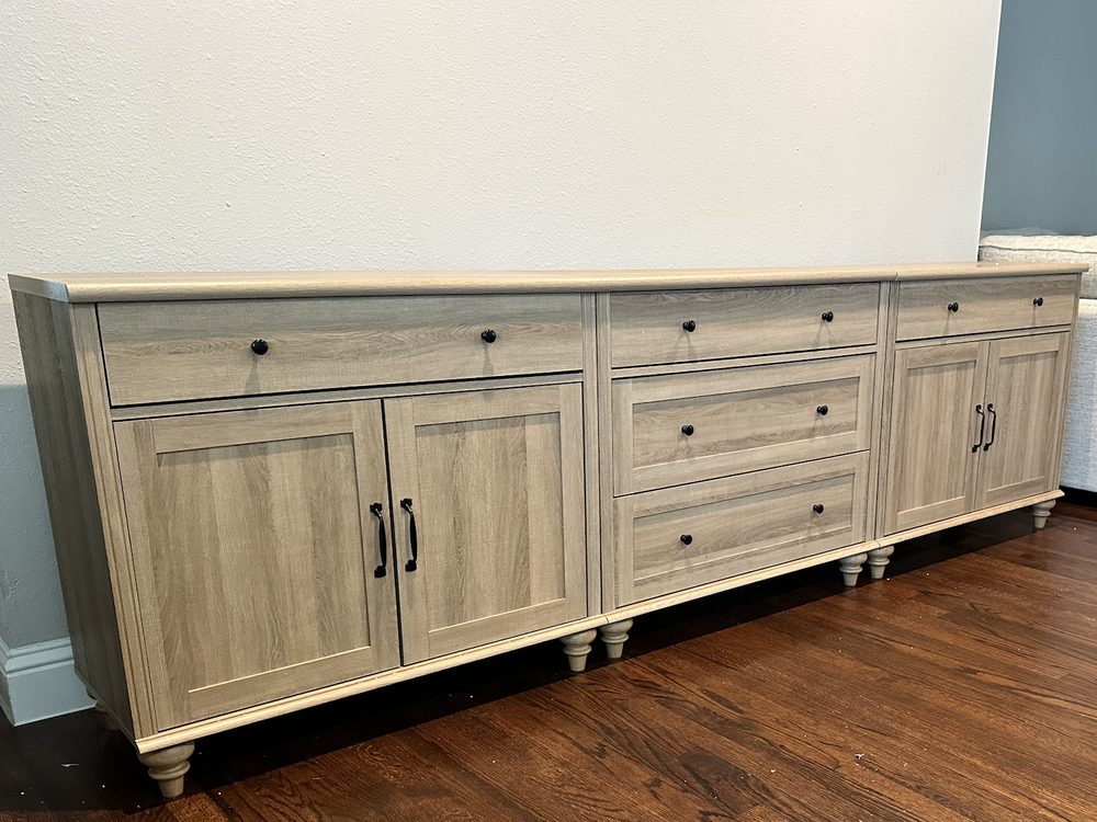 Assembled Wayfair wood sideboard with drawers and cabinet doors in a Sparkman Club home in Dallas