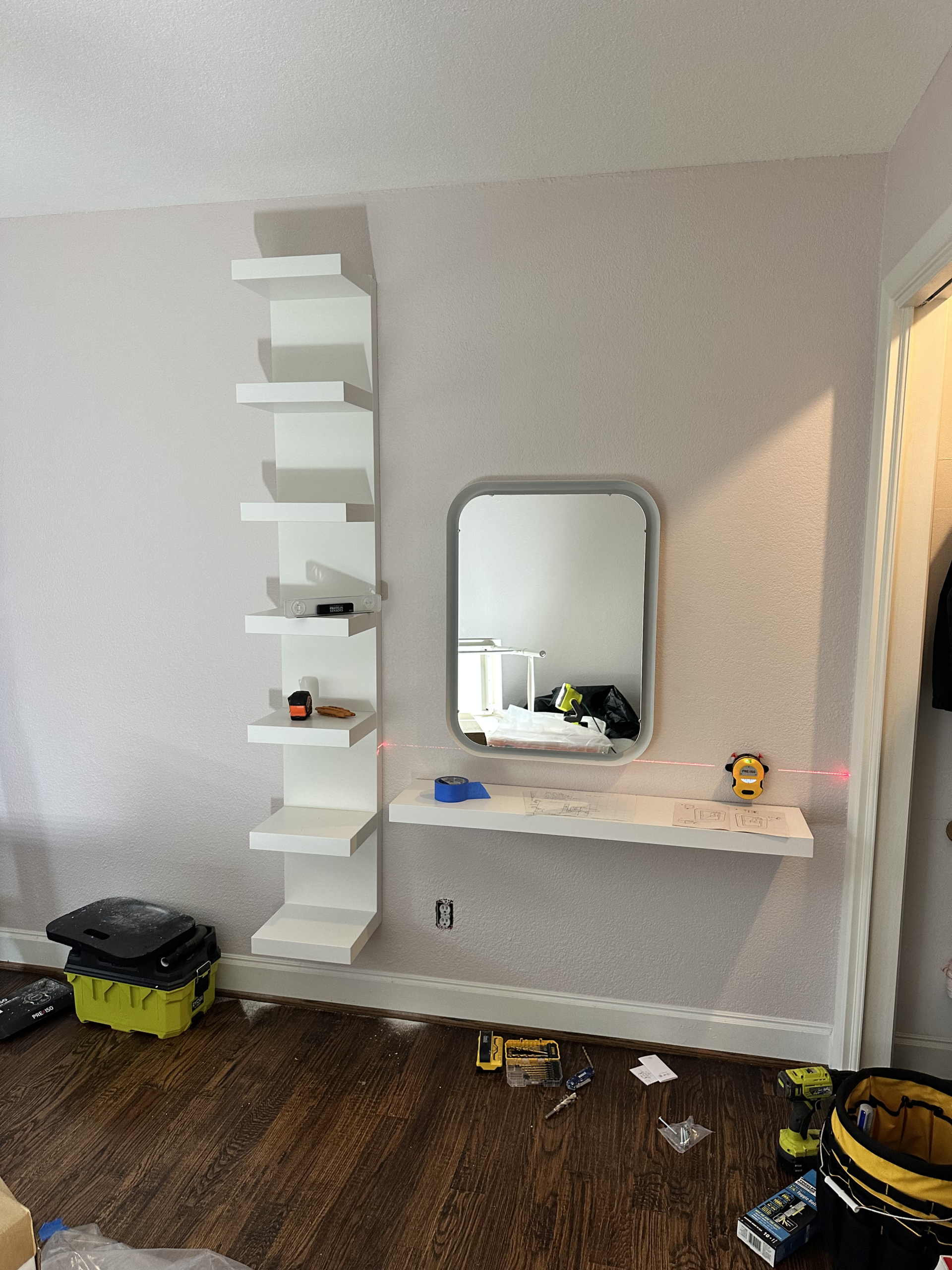 Floating makeup desk and mirror installed beside a tall white wall shelf unit on sheetrock in a Lakewood bedroom