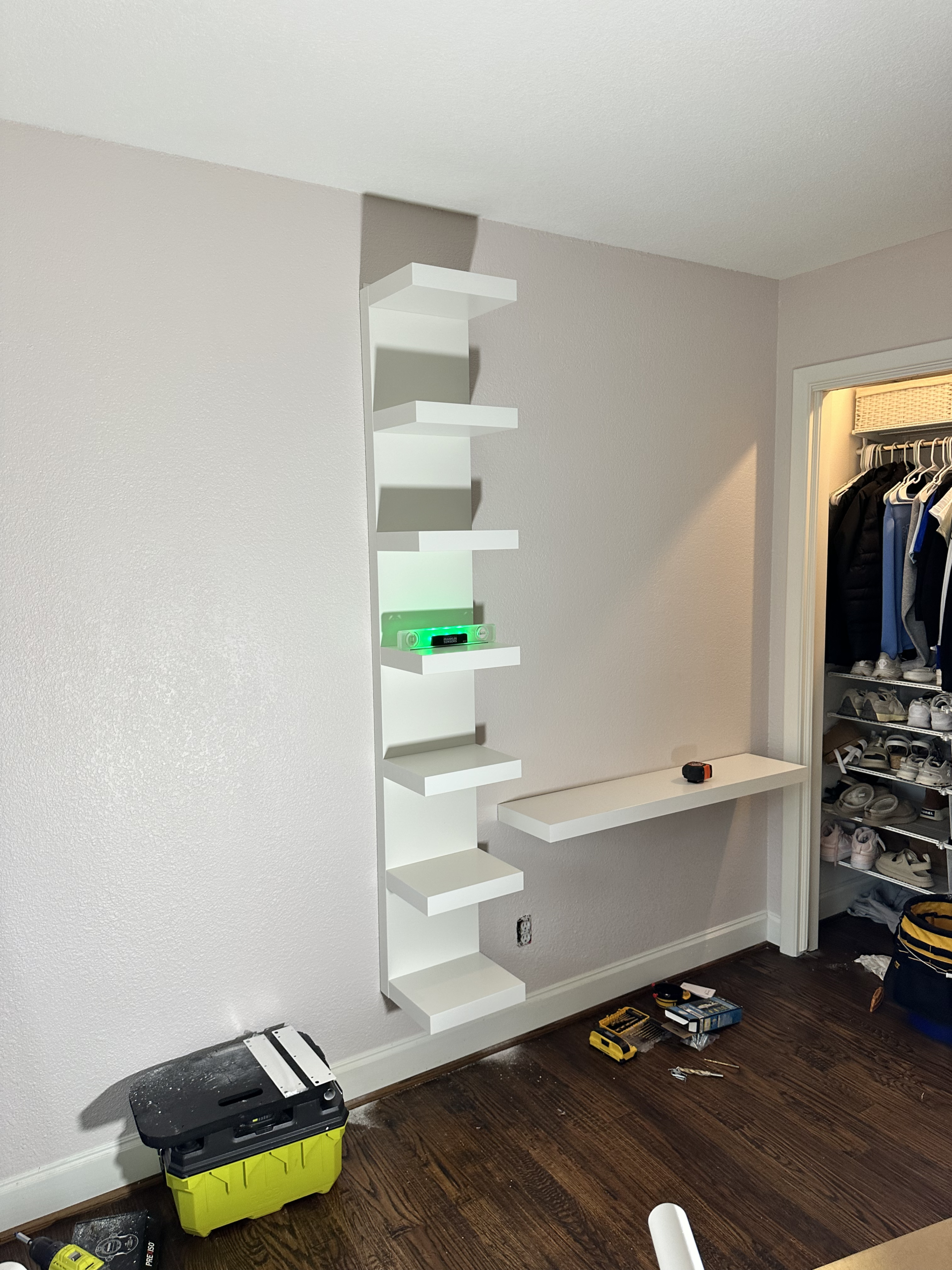 Tall white wall-mounted shelf unit and floating desk installed on sheetrock in a girls' bedroom in Lakewood, Dallas
