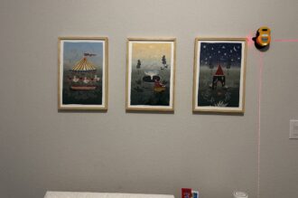 Three framed nursery prints hung in a level row, lined up with a laser level