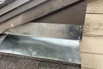 Completed wood rot repair with new metal flashing installed on roof fascia